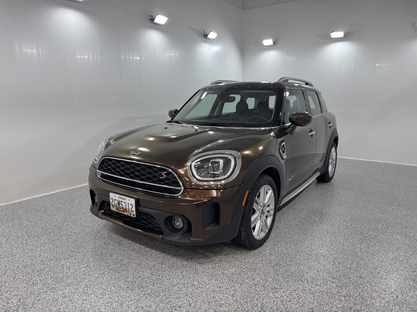 Brown Mini Countryman parked in detailing studio after full vinyl wrap and ceramic coating service at Capital Wrappers