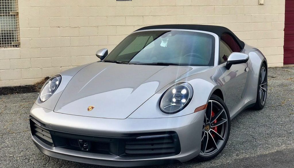 Silver Porsche convertible showcasing high-gloss ceramic coating finish at Capital Wrappers facility